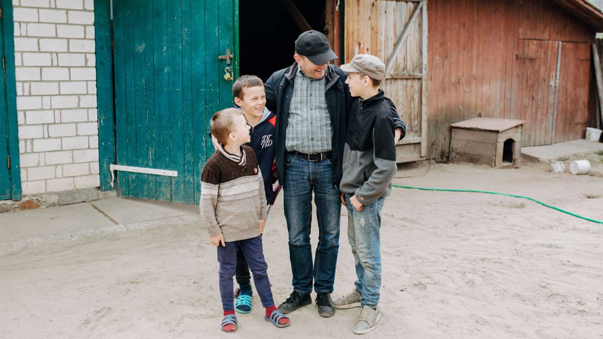 A coordinator with three smiling children.