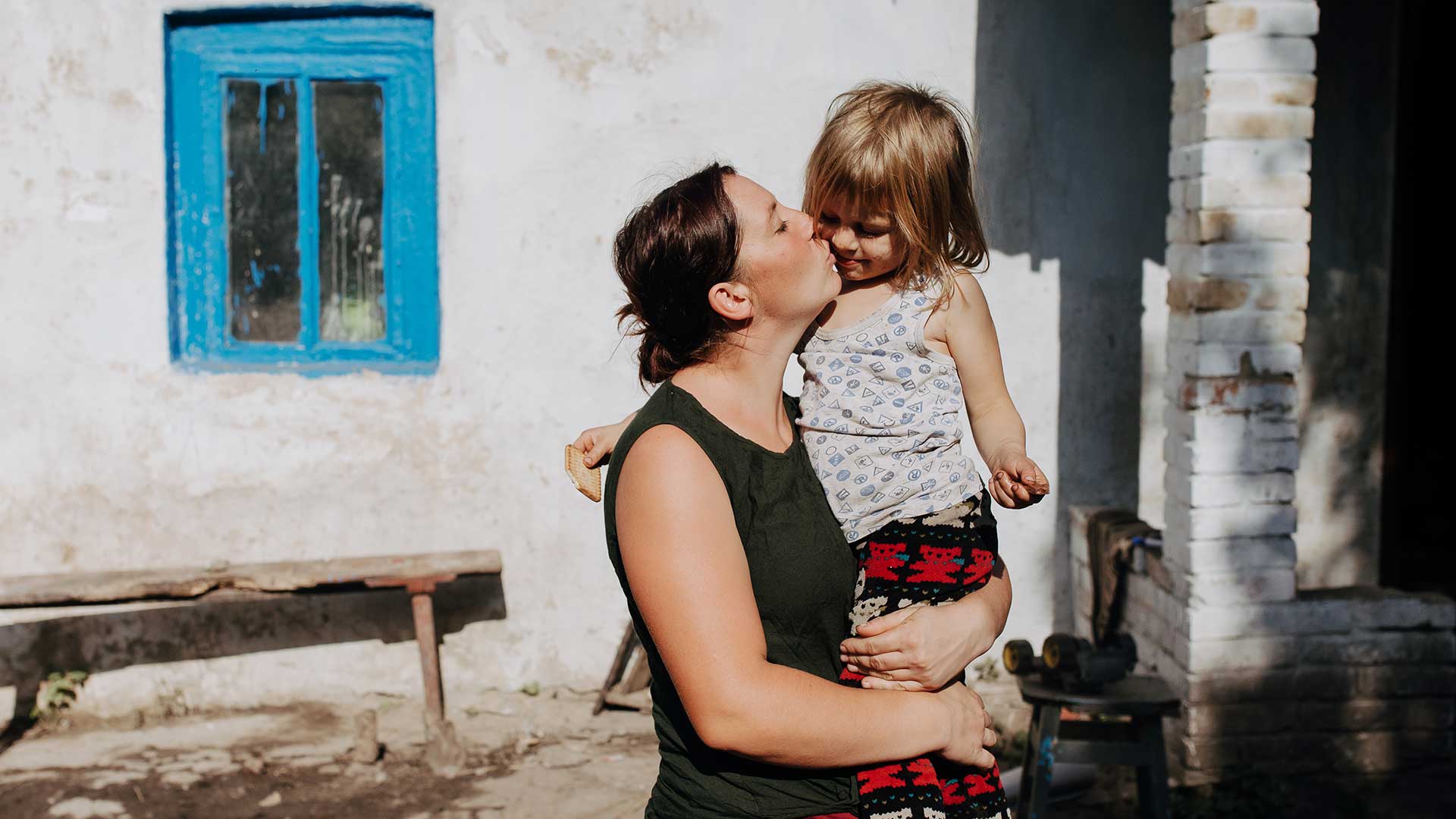A child receives a hug in Ukraine.