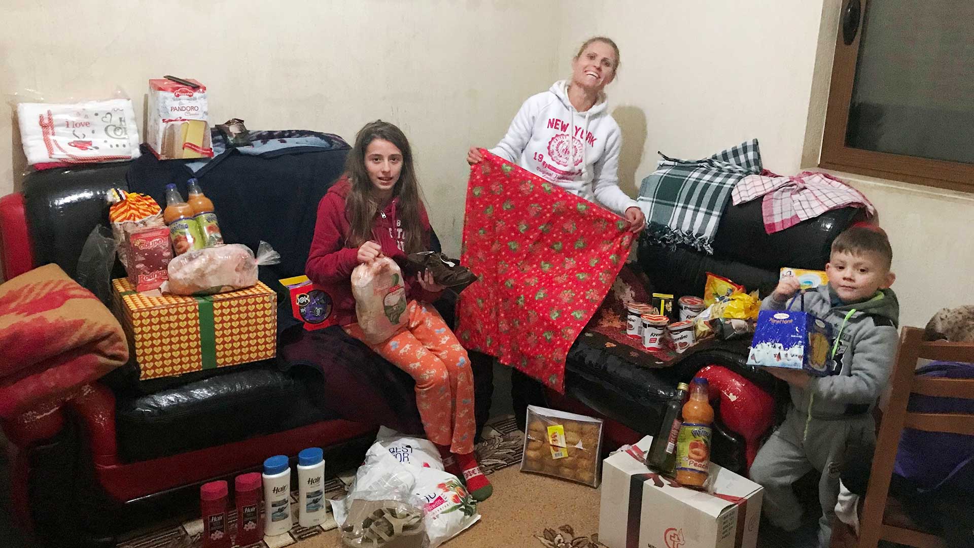 A family happy with Christmas gifts.