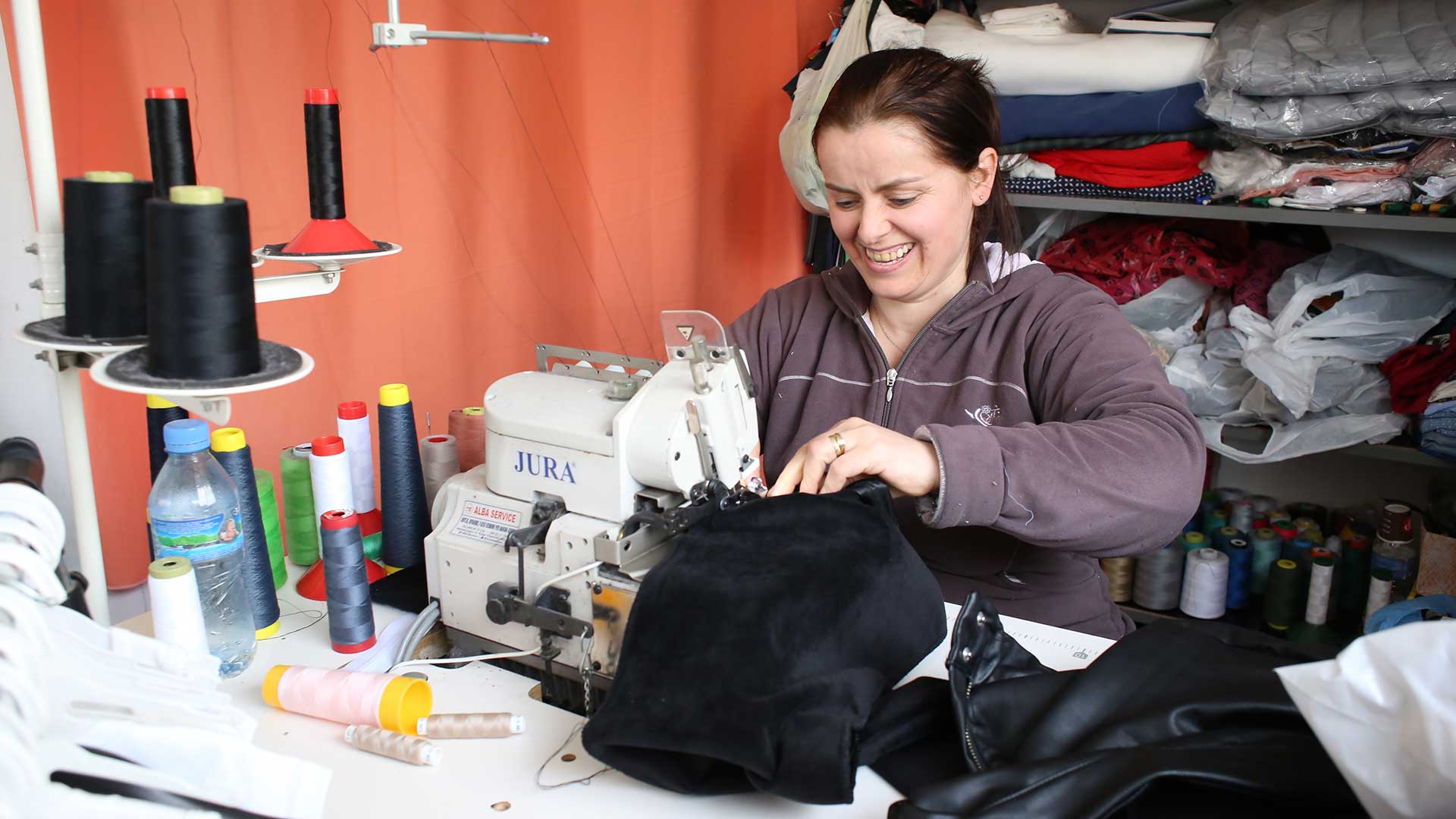 A woman happy with her new sewing machine.